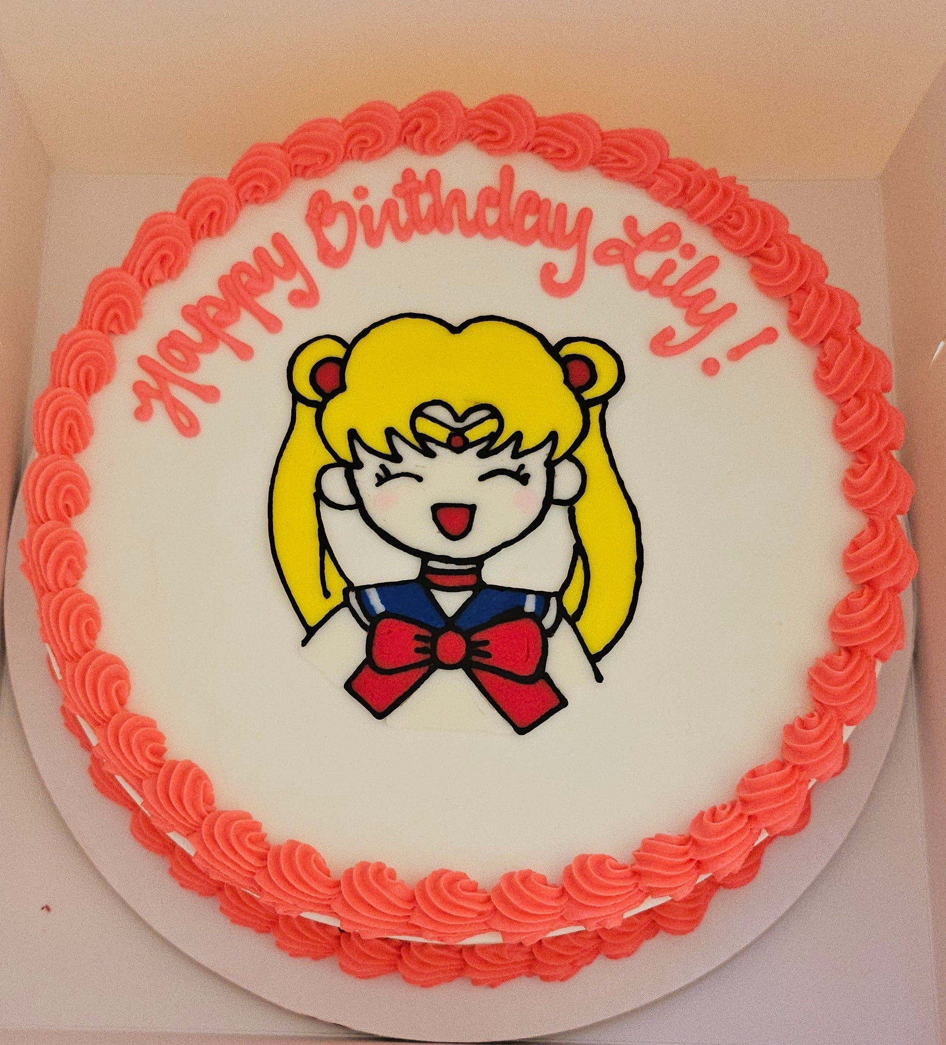 Birthday cake with cartoon character and 'Happy Birthday Lily!' text