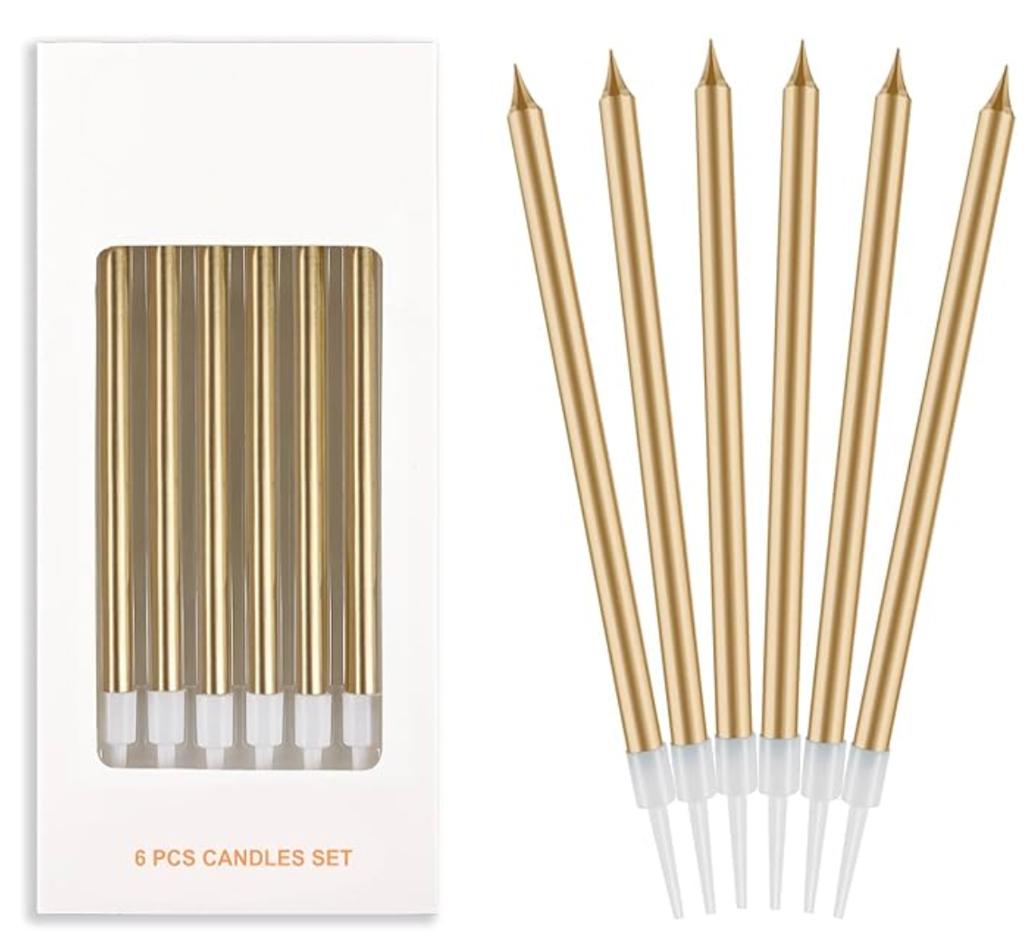Set of gold candles with white tips and packaging on a white background