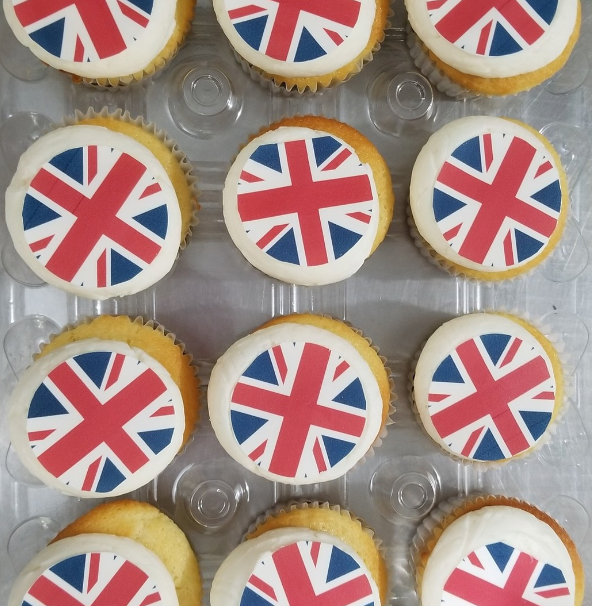Cupcakes with Union Jack flags on a clear cupcake tray